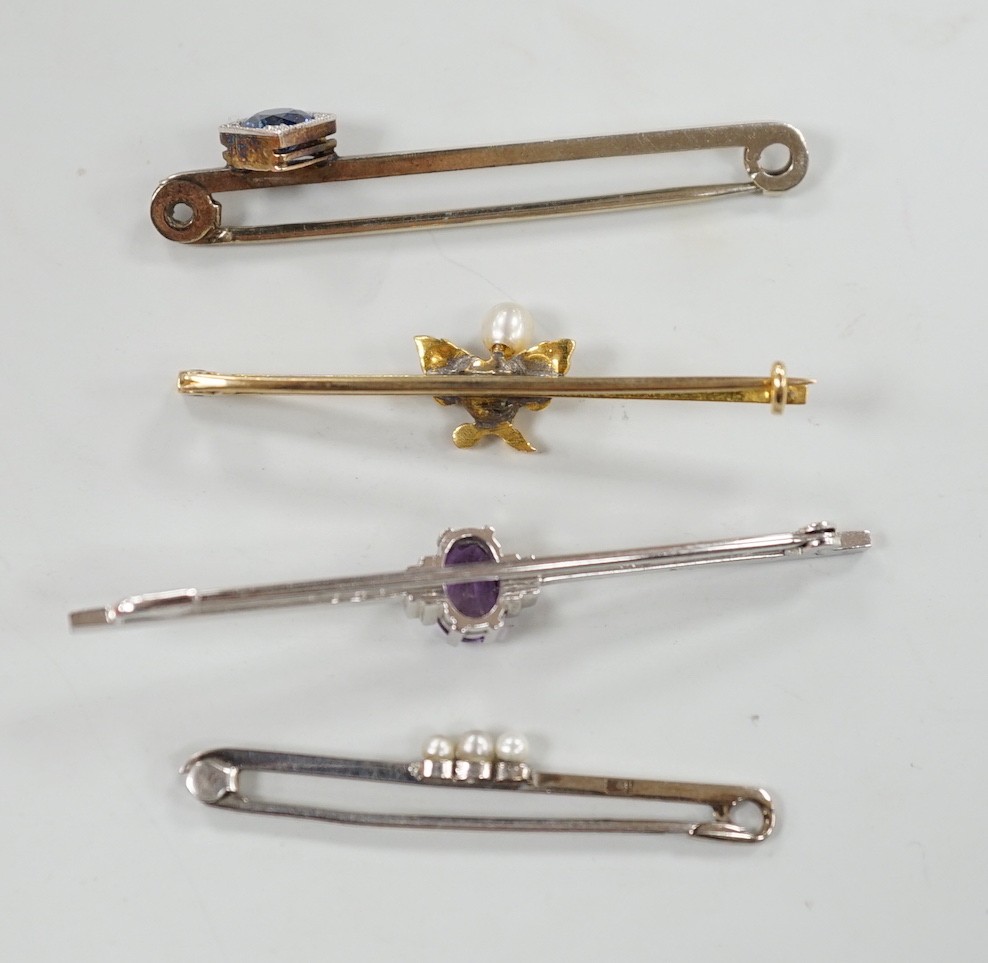 A 9ct white gold and synthetic? sapphire set bar brooch, 45mm and three other bar brooches including yellow metal and seed pearl, white metal and seed pearl and a 9ct and amethyst bar brooch, gross weight 8.1 grams.